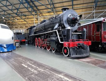 Vintage steam locomotive displayed in a railway museum, showcasing classic engineering and historical train design