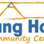 Tang Hall Community Centre logo featuring an orange roof outline and blue text, promoting local engagement and activities
