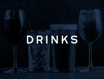 Assorted drinks in elegant glasses on a dark background, featuring wine, cocktails, and beer for a stylish bar setting
